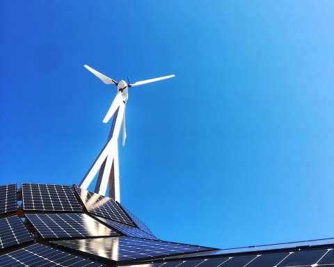 white wind turbine on top of a building