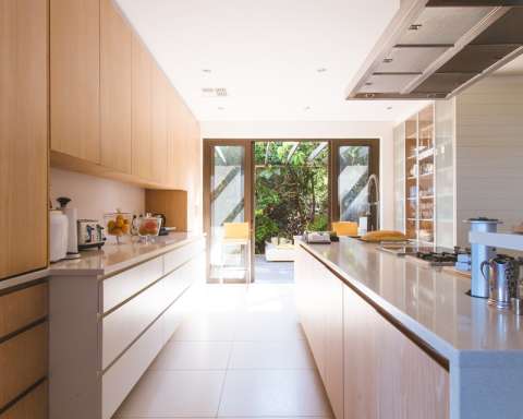 white wooden kitchen island and cupboard cabinets near glass panel door