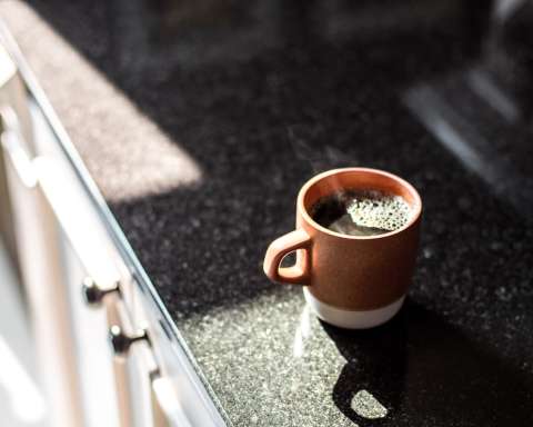 brown and white ceramic mug on table