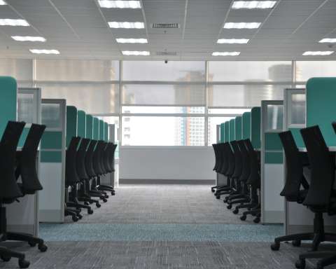 empty black rolling chairs at cubicles