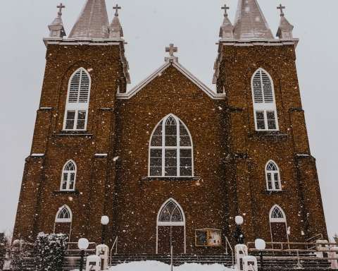 a church with a lot of snow on the ground