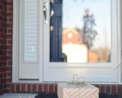 four brown gift boxes near white door