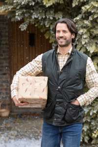 a man is holding a box in the snow