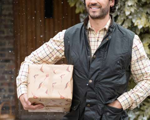 a man is holding a box in the snow