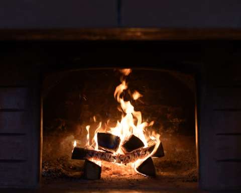 a fire burning inside of a brick oven