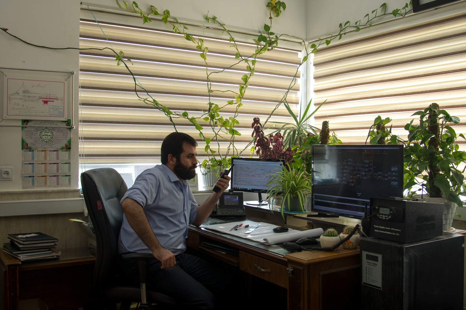 man in gray crew neck t-shirt sitting on black office rolling chair